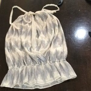 Peplum top. Ties behind the neck.